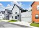 Contemporary two-story home in gray, with a front-entry two-car garage, covered entry, and second story deck at 1834 Rosette Way, Indianapolis, IN 46202