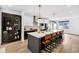 A modern kitchen featuring a large island with seating, black cabinets, and stainless steel appliances at 1834 Rosette Way, Indianapolis, IN 46202