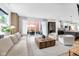 Bright living room with modern furniture, access to patio, and adjacent kitchen with island at 1834 Rosette Way, Indianapolis, IN 46202