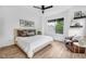 Bright main bedroom featuring a ceiling fan, a queen-size bed, and an accent chair at 1834 Rosette Way, Indianapolis, IN 46202