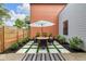 Charming outdoor patio featuring a dining table set for four, surrounded by lush greenery at 1834 Rosette Way, Indianapolis, IN 46202