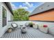 Charming patio featuring sleek seating, a modern fire pit, and beautiful plants in decorative planters at 1834 Rosette Way, Indianapolis, IN 46202