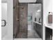 Walk-in shower featuring sleek fixtures, grey tile surround, and glass door at 1834 Rosette Way, Indianapolis, IN 46202