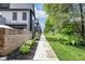 Picturesque street view of modern townhomes with sidewalks bordered by lush green grass and mature trees at 1834 Rosette Way, Indianapolis, IN 46202