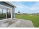 A concrete patio with a sliding door to a yard with a pond at 18955 Seaforth Way, Westfield, IN 46074