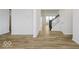 Open hallway features hardwood floors leading to the stairs at 18955 Seaforth Way, Westfield, IN 46074