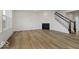 Bright living room features hardwood floors, a fireplace, and stairs at 18955 Seaforth Way, Westfield, IN 46074
