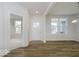 Bright living room with hardwood floors, white walls, and large windows for natural light at 18955 Seaforth Way, Westfield, IN 46074