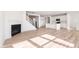 Open-concept living area featuring a fireplace, staircase, wood floors, and natural light at 18955 Seaforth Way, Westfield, IN 46074