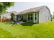 Spacious backyard with a patio area featuring a hot tub, grill, and comfortable seating at 18973 Elder Ridge Dr, Noblesville, IN 46062