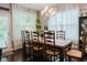 Elegant dining room with traditional wood table, chandelier, and large windows with sheer curtains at 18973 Elder Ridge Dr, Noblesville, IN 46062