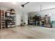 Spacious garage offers ample storage with shelving units and includes a refrigerator at 18973 Elder Ridge Dr, Noblesville, IN 46062