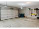 Spacious garage with neutral walls has an open door, storage space, and an epoxy floor at 18973 Elder Ridge Dr, Noblesville, IN 46062
