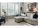 Sunlit living room with a comfortable sectional sofa, neutral carpet, and decorative accents at 18973 Elder Ridge Dr, Noblesville, IN 46062