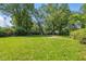 Spacious backyard with lush green grass and mature trees at 1931 Brentwood Dr, Anderson, IN 46011
