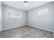 Bright bedroom with two windows and stylish gray wood-look flooring at 1931 Brentwood Dr, Anderson, IN 46011