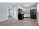 Efficient kitchen with black appliances, white cabinets, hardwood floors, and an open layout at 1931 Brentwood Dr, Anderson, IN 46011