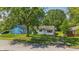 Neighborhood street view of home featuring a green lawn and mature trees at 1931 Brentwood Dr, Anderson, IN 46011
