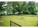 Expansive green backyard with a chainlink fence, mature trees, and a well-maintained lawn at 196 Park Ave, Bargersville, IN 46106