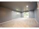 Finished basement with neutral carpet, white trim, and walkout to backyard at 196 Park Ave, Bargersville, IN 46106