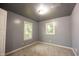 Bedroom with neutral carpet, white trim, gray walls, and two windows at 196 Park Ave, Bargersville, IN 46106