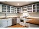 Well-lit kitchen with white cabinets, butcher block countertops, and stainless steel appliances at 196 Park Ave, Bargersville, IN 46106