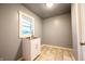 Laundry room with white walls, a stainless steel utility sink, and a window at 196 Park Ave, Bargersville, IN 46106