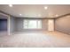 Spacious living room with plush carpeting, a bright window and modern recessed lighting at 196 Park Ave, Bargersville, IN 46106