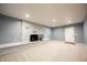 Bright living room with a whitewashed fireplace and neutral carpeting at 196 Park Ave, Bargersville, IN 46106