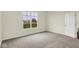 Carpeted bedroom with a window overlooking a peaceful landscape, next to bathroom and kitchen at 2021 Frost Line Ln, Greenfield, IN 93927
