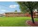 Large, well-maintained backyard with a brick home, manicured lawn, and a spacious wooden deck at 230 Love Ave, Greenwood, IN 46142