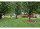 Spacious backyard with a deck, play set, shed, and lush green grass at 230 Love Ave, Greenwood, IN 46142