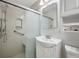 Bathroom with white cabinets, sink, commode, and a shower with sliding glass door and grab bar at 230 Love Ave, Greenwood, IN 46142