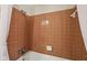 Bathroom featuring orange tiles, a shower head, a bathtub with chrome hardware, and a white shower curtain at 230 Love Ave, Greenwood, IN 46142