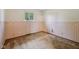 Empty carpeted bedroom featuring a small window, two tone wallpaper, and tan carpet at 230 Love Ave, Greenwood, IN 46142
