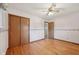 Bedroom with hardwood floors, ceiling fan, and view of closet and door to another room at 230 Love Ave, Greenwood, IN 46142
