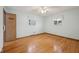 Bedroom featuring hardwood floors, two windows, light blue walls, and a closet at 230 Love Ave, Greenwood, IN 46142