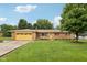 Charming single-story brick home with well-maintained lawn and vibrant yellow garage door at 230 Love Ave, Greenwood, IN 46142