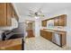 Well-lit kitchen with stainless steel appliances and wood cabinets open to the living area at 230 Love Ave, Greenwood, IN 46142