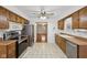 Bright kitchen with stainless steel appliances and wood cabinetry overlooking the Gathering room at 230 Love Ave, Greenwood, IN 46142