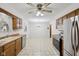 Open kitchen leading to dining area, featuring stainless steel appliances and wood cabinets at 230 Love Ave, Greenwood, IN 46142