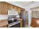 Close-up of stainless appliances and wood cabinets; functional and stylish at 230 Love Ave, Greenwood, IN 46142
