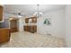 Eat-in kitchen with classic cabinetry, chandelier lighting, and a stainless steel dishwasher at 230 Love Ave, Greenwood, IN 46142