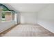 Spacious living room featuring neutral paint, plush carpeting, and large bright window at 230 Love Ave, Greenwood, IN 46142