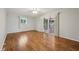Bright living room with hardwood floors, ceiling fan, paneled walls, and deck access via sliding glass doors at 230 Love Ave, Greenwood, IN 46142