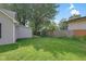 Backyard view with green grass and partial fence, and featuring mature trees at 26098 Six Points Rd, Sheridan, IN 46069