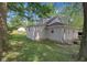 Backyard of home featuring a lush green lawn surrounded by mature trees at 26098 Six Points Rd, Sheridan, IN 46069