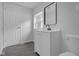 Modern bathroom with black mirror, white vanity, and tiled shower at 26098 Six Points Rd, Sheridan, IN 46069