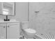 Renovated bathroom featuring a new vanity, toilet, mirror, and elegant marble-look tiling at 26098 Six Points Rd, Sheridan, IN 46069