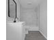 Bathroom featuring a black framed mirror and shower with marble tiling at 26098 Six Points Rd, Sheridan, IN 46069